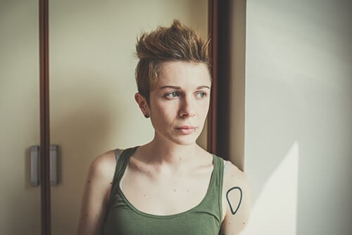 young individual in need of a LGBTQ+ addiction treatment program