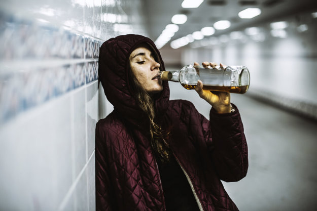 young woman drinking although she is asking how long does it take to detox from alcohol