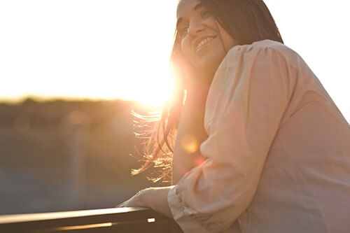 young woman thriving as she follows the relapse prevention plan California offers