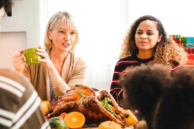 sober-thanksgiving (1) two woman with their family are celebrating a sober thanksgiving