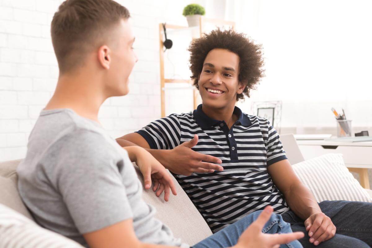 two men conversing on a couch about LGBTQ rehab centers