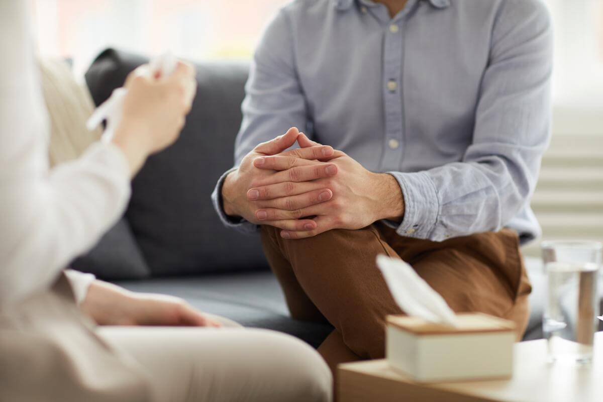 man speaking to therapist about long-term recovery programs for addiction treatment