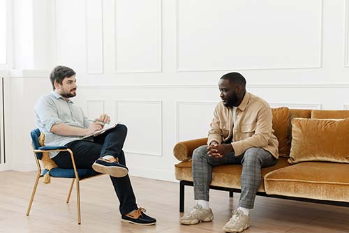 two men in a therapy session discussing short-term outpatient rehab
