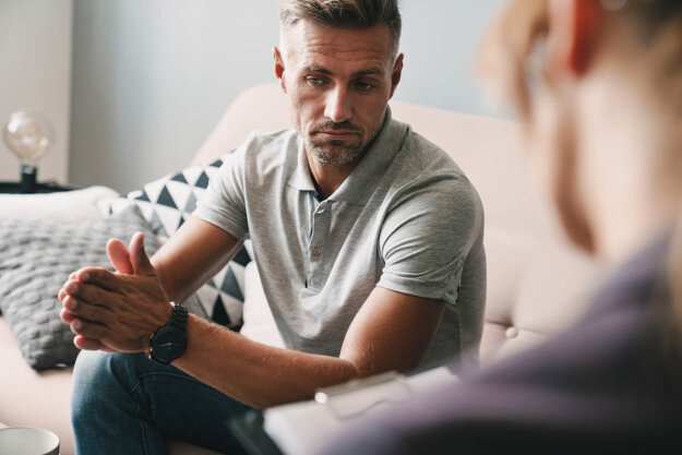 7 Common Fentanyl Usage Signs young man meeting with addiction specialist in an office setting discussing the 7 common fentanyl usage signs