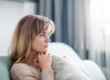 Woman sits on couch and wonders what prescription drug abuse looks like