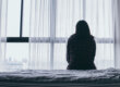 woman looking out of window considers the early signs of addiction you shouldn't ignore
