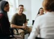 man talks with peers in group therapy about what to expect in the first week of rehab