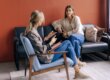 Two women sitting in a counseling session discussing mental health and recovery in a calm office