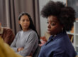Black woman speaking in group therapy